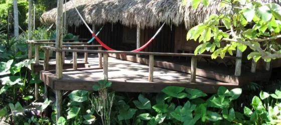 Relax on the deck at Lamanai Outpost Lodge