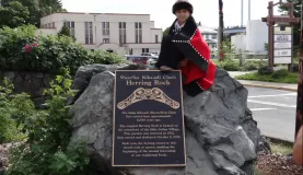 Tlingit boy sit on the monument