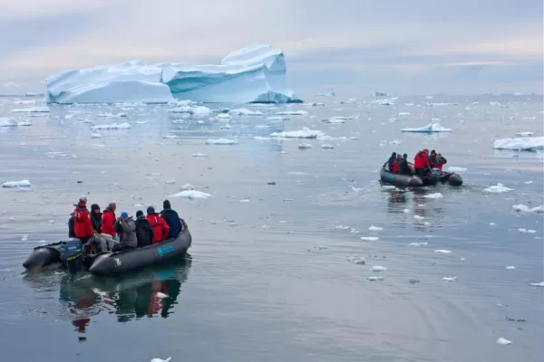 Travelers exploring the arctic with zodiacs.