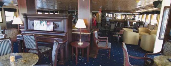 Relax in the Grand Salon aboard the SS Legacy.