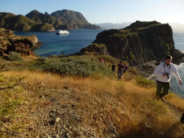 Travelers hiking up the coast.