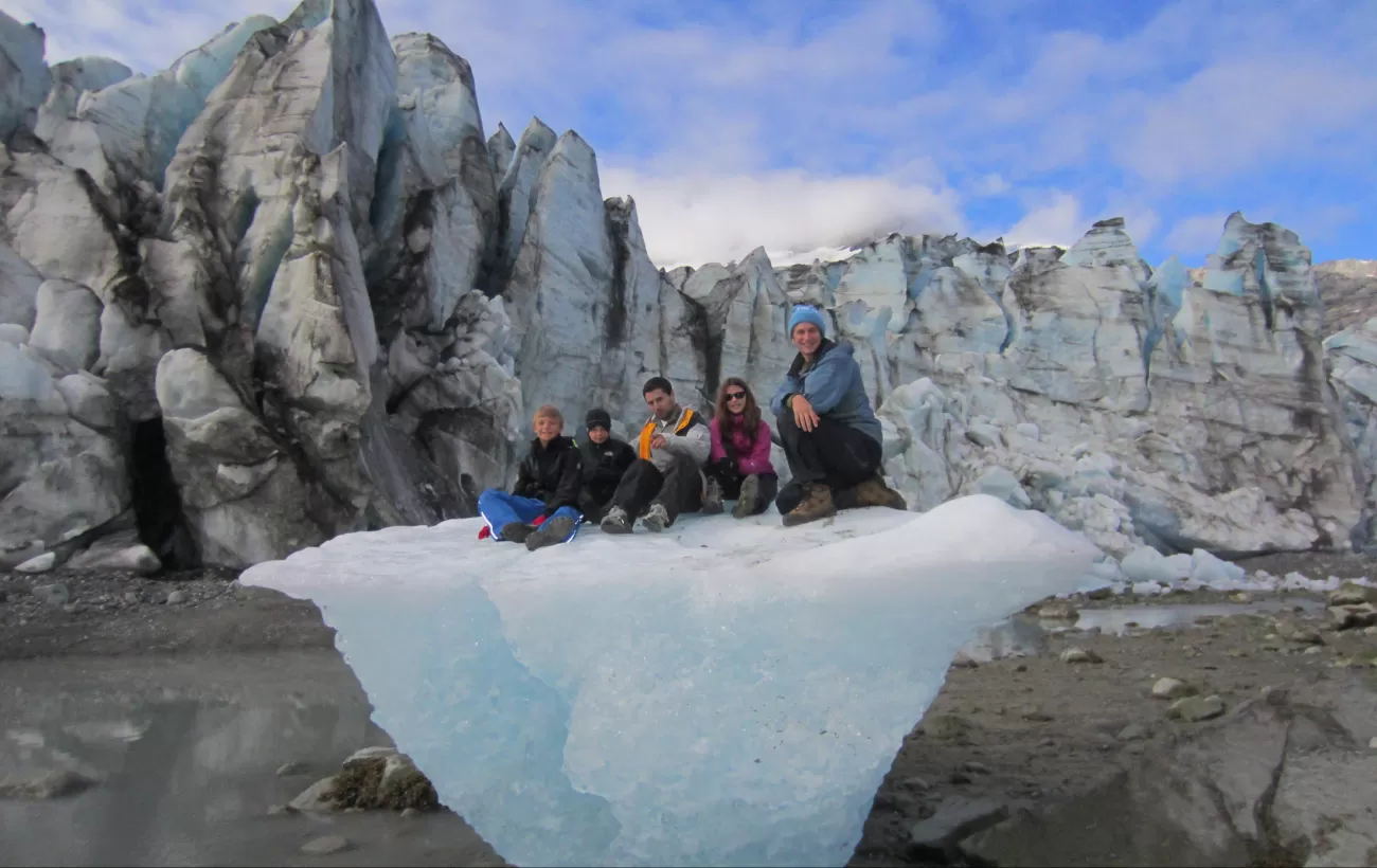 Family sitting on a glacier.
