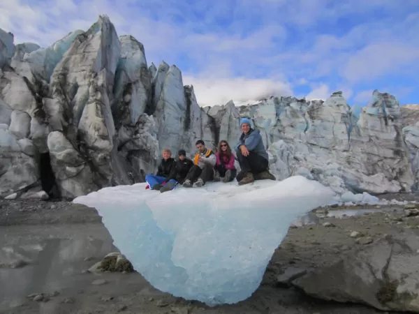 Family sitting on a glacier.