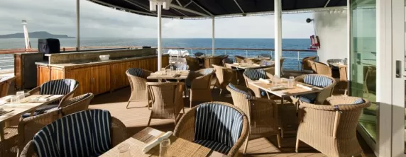Enjoy a meal on the sun deck of the Isabela II.