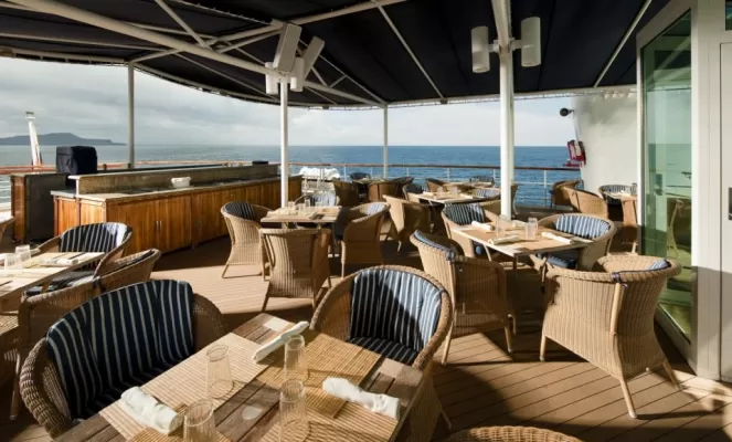 Enjoy a meal on the sun deck of the Isabela II.