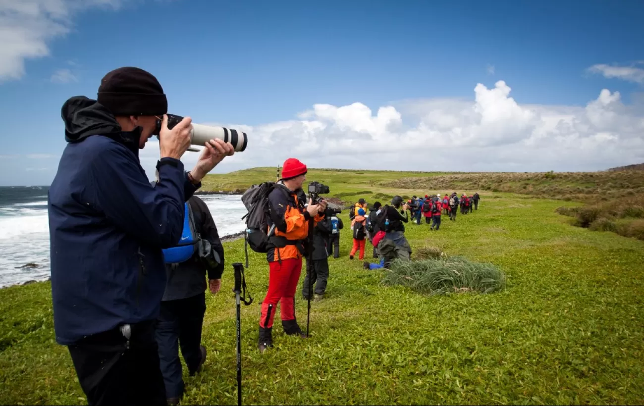 Travelers photographing the subantarctic landscape.