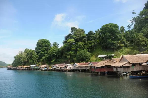 Houses line the coast of the Melanesia islands.