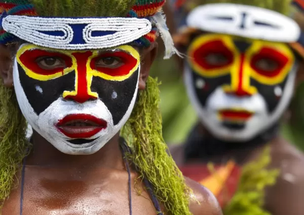 Locals of Papua New Guinea dressed in traditional headdress.