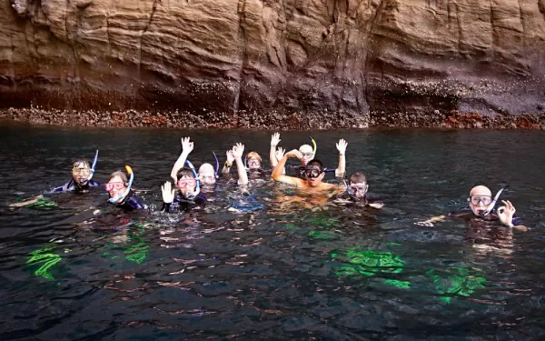 Travelers snorkeling in the beautiful Galapagos waters.