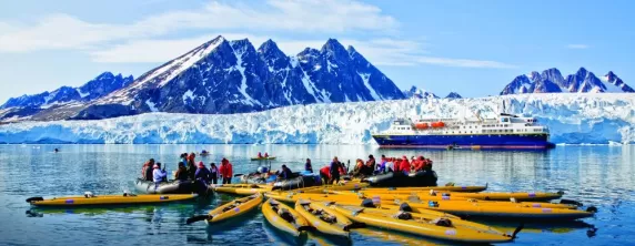 Taking a kayaking trip around Monaco Glacier on Spitsbergen Island.