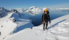 Hiking to the top of an icy peak.
