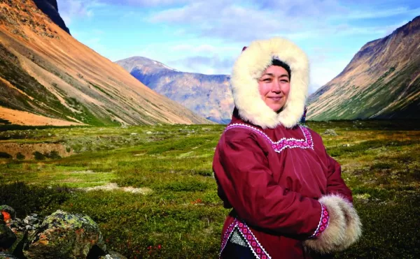 A local stands in traditional dress for the arctic.