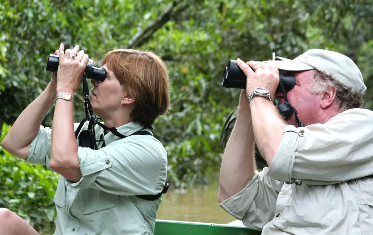 Traveler's looking at local wildlife through binoculars.
