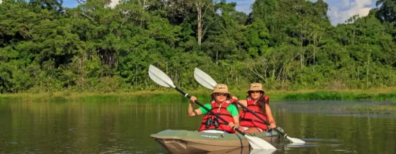 Two kayakers making their way down the Amazon River.