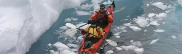Kayaking through arctic waters.
