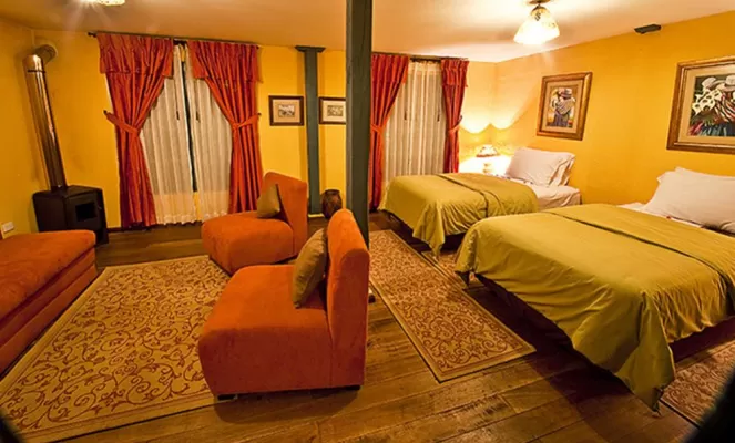 An in-room fireplace keeps this double room cozy at Hacienda El Porvenir