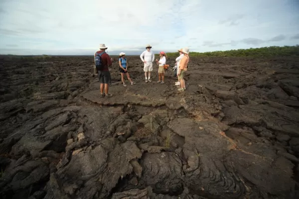 Travelers being guided across the volcanic landscape.