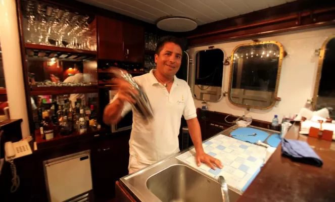 The bartender mixes a drink aboard the Mary Anne.