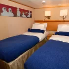 Relax in your standard room aboard the Galapagos Legend
