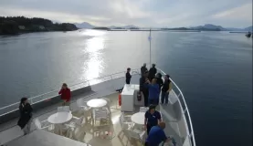 Passengers sightseeing from the bow of the boat