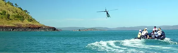 Helicopter leads a zodiac in the Southern Pacific