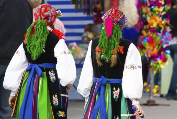 Locals of Poland wearing colorful traditional clothing.