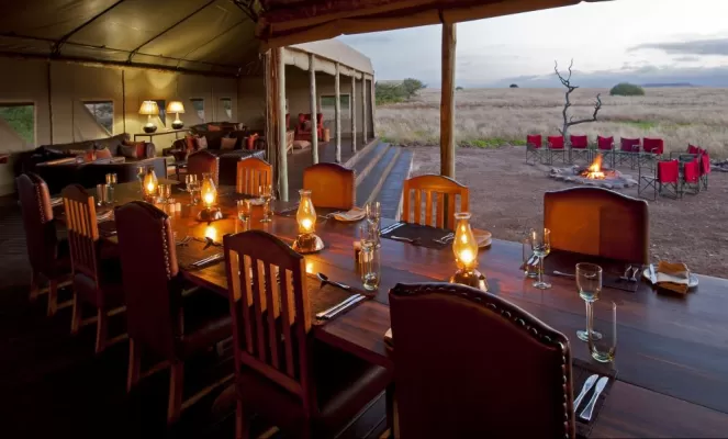 Enjoy a delicious meal while watching the sun set over the beautiful landscape.