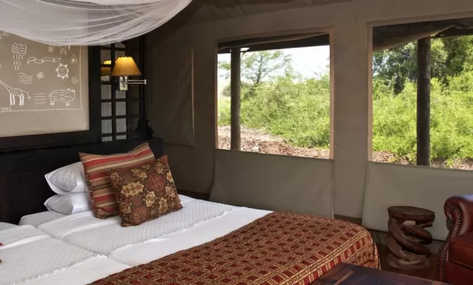 Relax in these comfortable and unique rooms at the Desert Rhino Camp