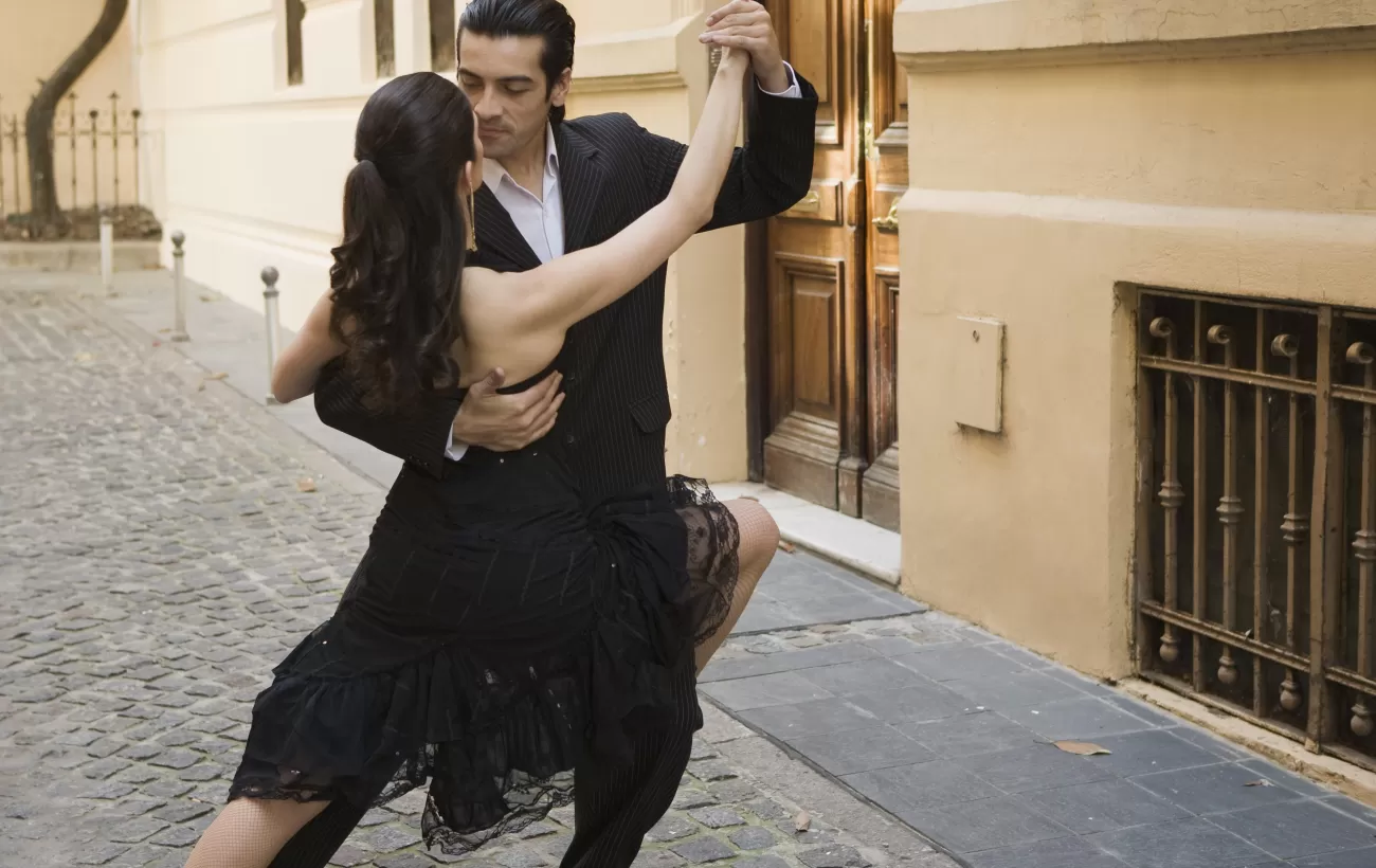 A young couple dances a traditional tango in the streets of Buenos Aires