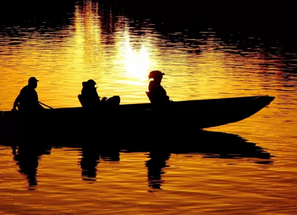 A motorized canoe crosses the still waters of the region