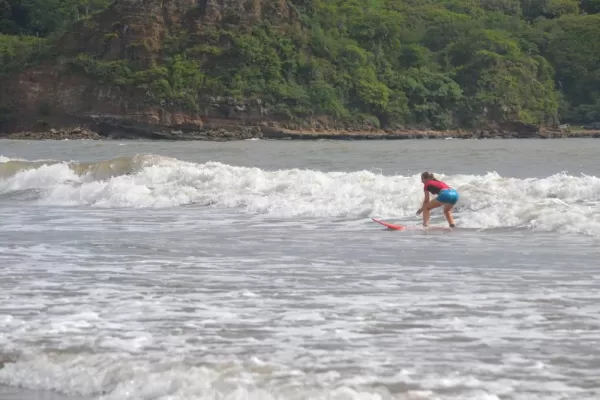A new surfer catches a wave off the coast of Nicaragua