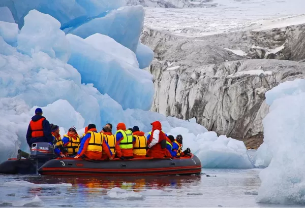 Cruise by zodiac to get up close and personal with Arctic icebergs