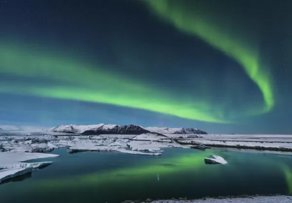 The northern lights dance over the Arctic landscape