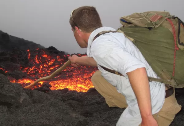 Joe plays with the lava of Pacaya Volcano