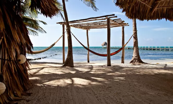 Relax on the large, sunny beach at Pelican Reef Villas