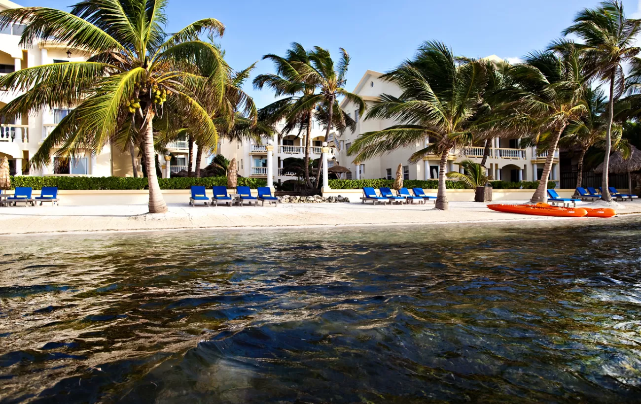 Relax on the large, sunny beach at Pelican Reef Villas