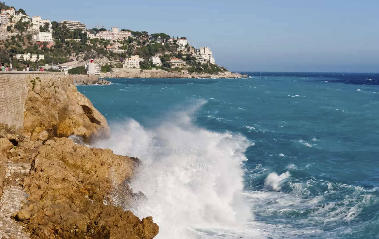 Waves crash against the beaches of Nice, France