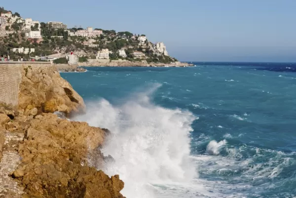Waves crash against the beaches of Nice, France