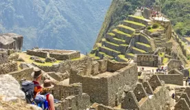 Couple looks out over Machu Picchu