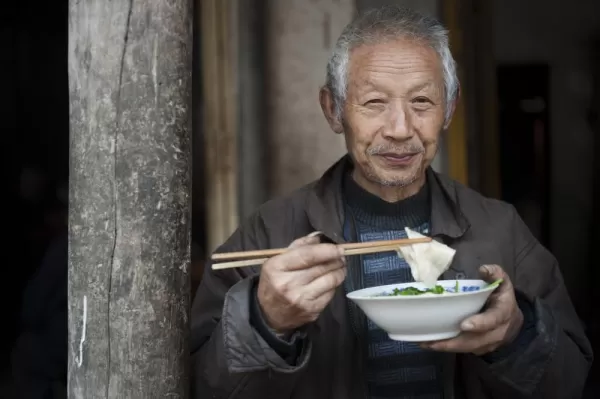 Chinese man enjoying his soup