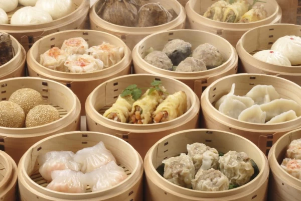 Variety of dim sum steamed in traditional bamboo containers