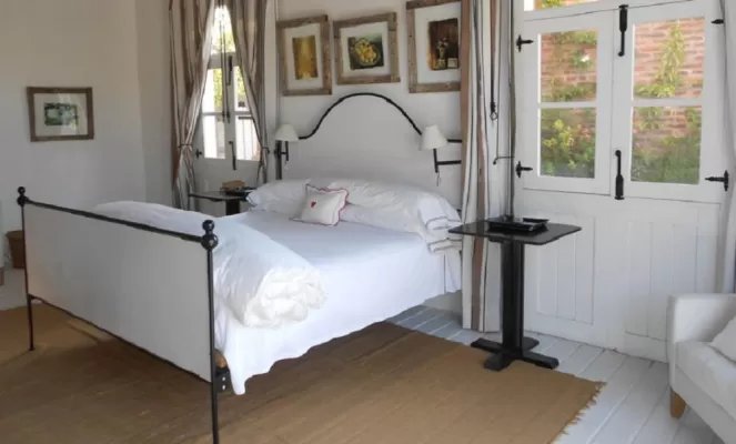 Bedrooms feature locally made wrought-iron beds and photography