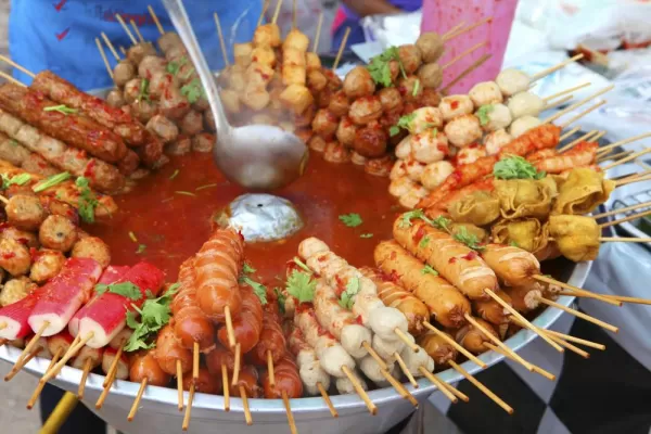 Typical street food in Thailand, meat and seafood on sticks