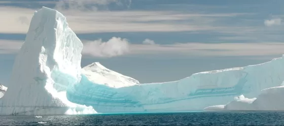 An iceburg curves with the horizon