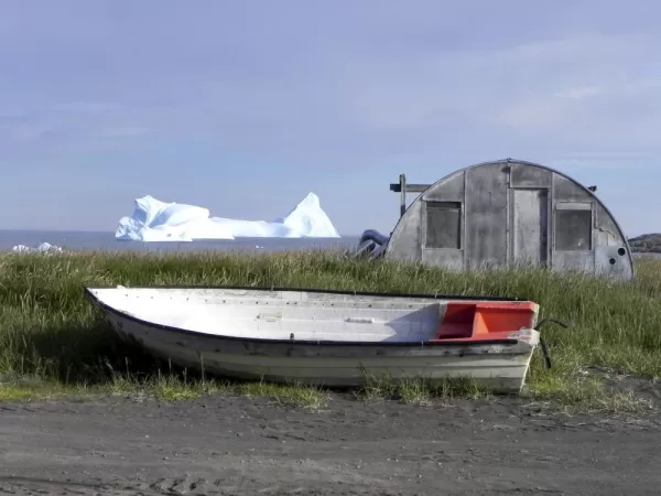 Boat, barn, and iceberg on Disko Bay