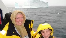My mom and son in front of their first iceberg