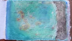 collage and painted map of Galapagos, with sand added for texture