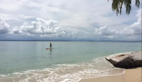 Matt paddle boarding off the island