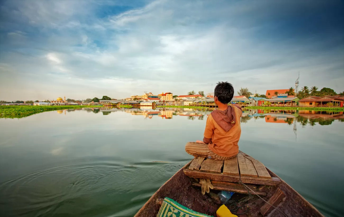 Boy on wooden fishing boat