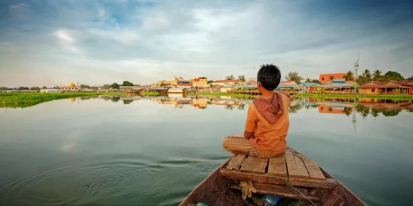 Boy on wooden fishing boat